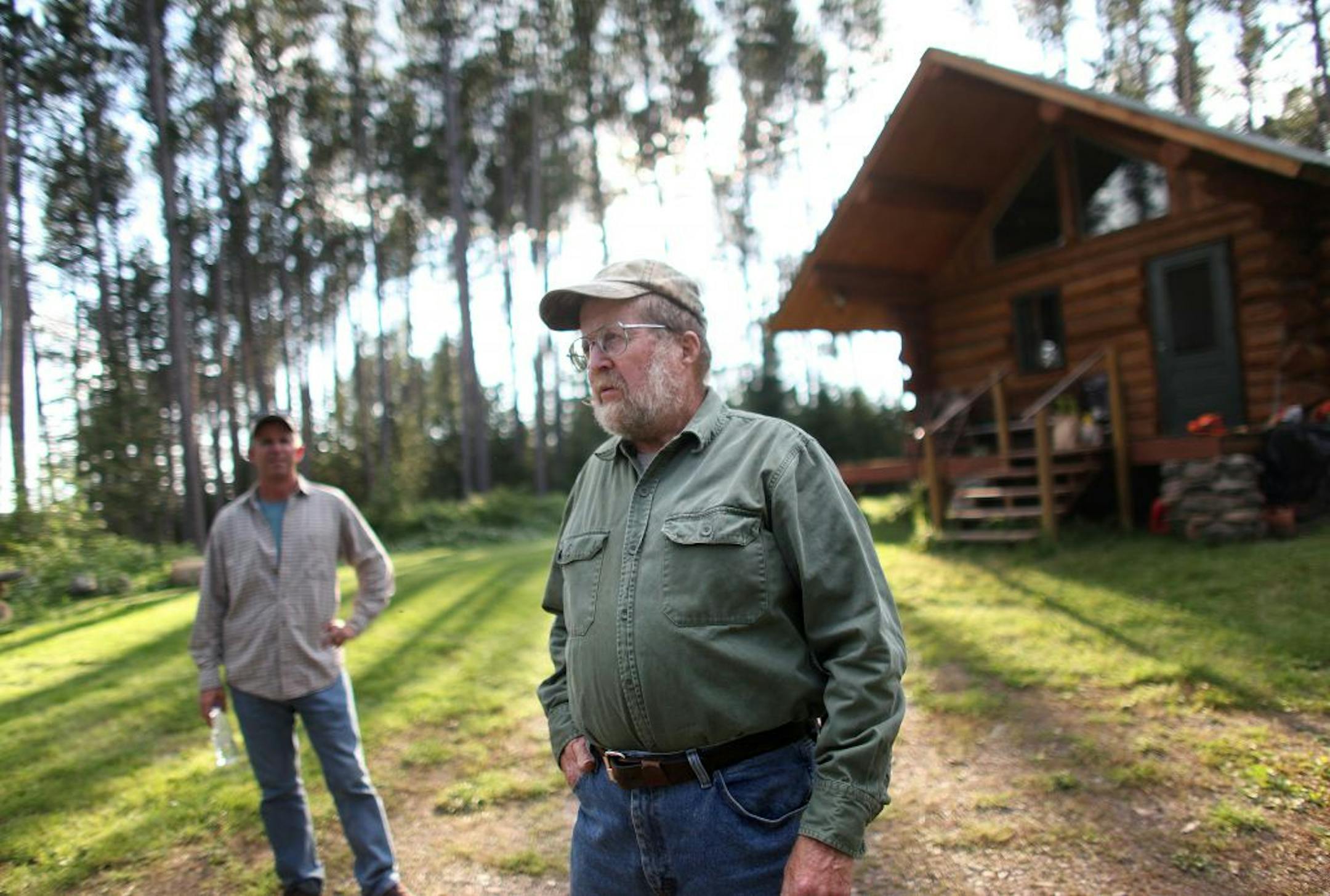 Ron Brodigan and his son Steve Brodigan (left) stood on Steve's property that neighbors Ron's on Sunday, August 14, 2011, near Ely, Minn. Ron and his son live on one of the largest untapped deposits of copper and nickel in the world and can do nothing to stop potential future mining on their private properties. (RENEE JONES SCHNEIDER/ reneejones@startribune.com) Ron and Steve Brodigan