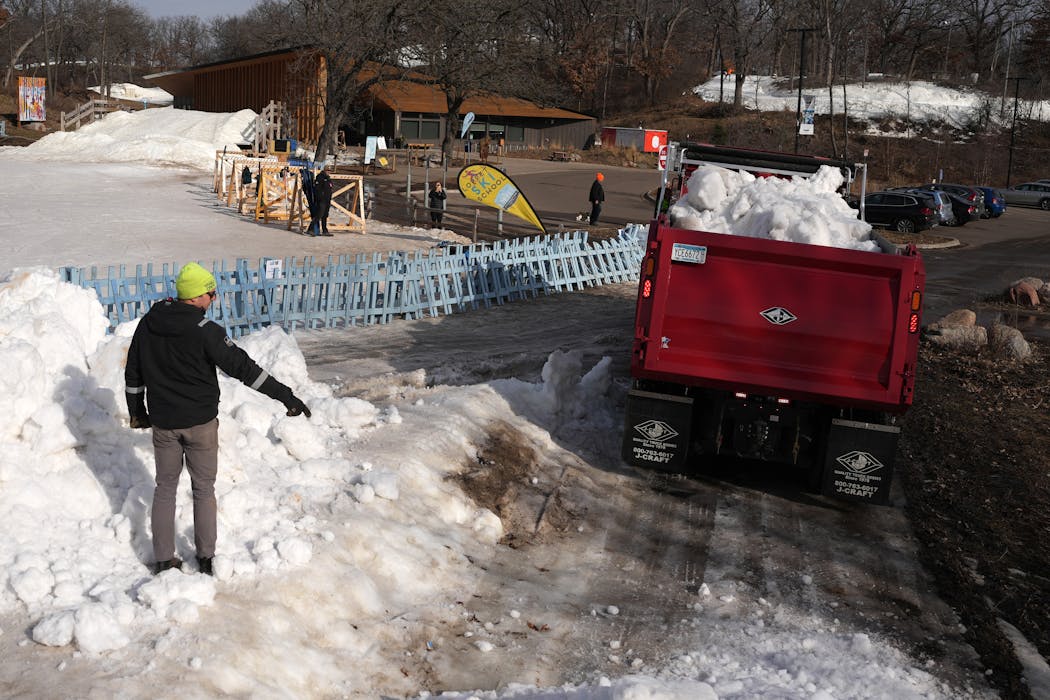 Robert Ibler, trails and operations manager for the Loppet Foundation, guided a driver into place as truckloads of snow, transported from Bloomington, were dumped in Theodore Wirth Park before the world championship Nordic ski race.