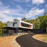 Nestled in the prairie on a gentle slope overlooking a pond, a site in Bloomington presented the perfect opportunity to build a net-zero home. The all-electric, highly insulated house with triple-pane windows, high-efficiency appliances, LED lighting, solar-paneled roof and geothermal heat pump system produces as much electricity as it consumes. Cedar accents and black corrugated metal help define the home’s elegance, as does a dream kitchen, two-story living and dining space as well as screened porches that maximize outdoor views.