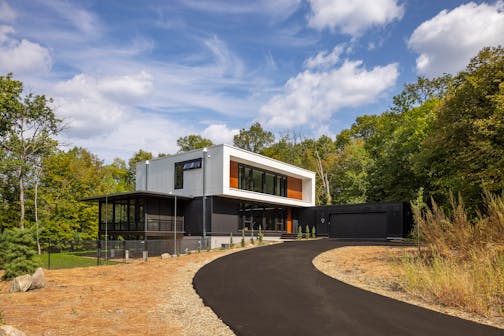 Nestled in the prairie on a gentle slope overlooking a pond, a site in Bloomington presented the perfect opportunity to build a net-zero home. The all-electric, highly insulated house with triple-pane windows, high-efficiency appliances, LED lighting, solar-paneled roof and geothermal heat pump system produces as much electricity as it consumes. Cedar accents and black corrugated metal help define the home’s elegance, as does a dream kitchen, two-story living and dining space as well as screened porches that maximize outdoor views.