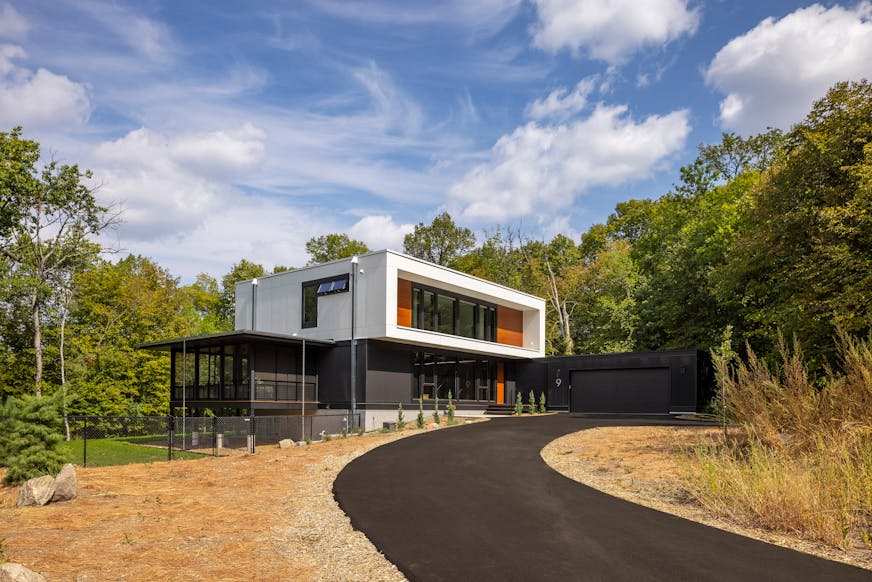 Nestled in the prairie on a gentle slope overlooking a pond, a site in Bloomington presented the perfect opportunity to build a net-zero home. The all-electric, highly insulated house with triple-pane windows, high-efficiency appliances, LED lighting, solar-paneled roof and geothermal heat pump system produces as much electricity as it consumes. Cedar accents and black corrugated metal help define the home’s elegance, as does a dream kitchen, two-story living and dining space as well as screened porches that maximize outdoor views.