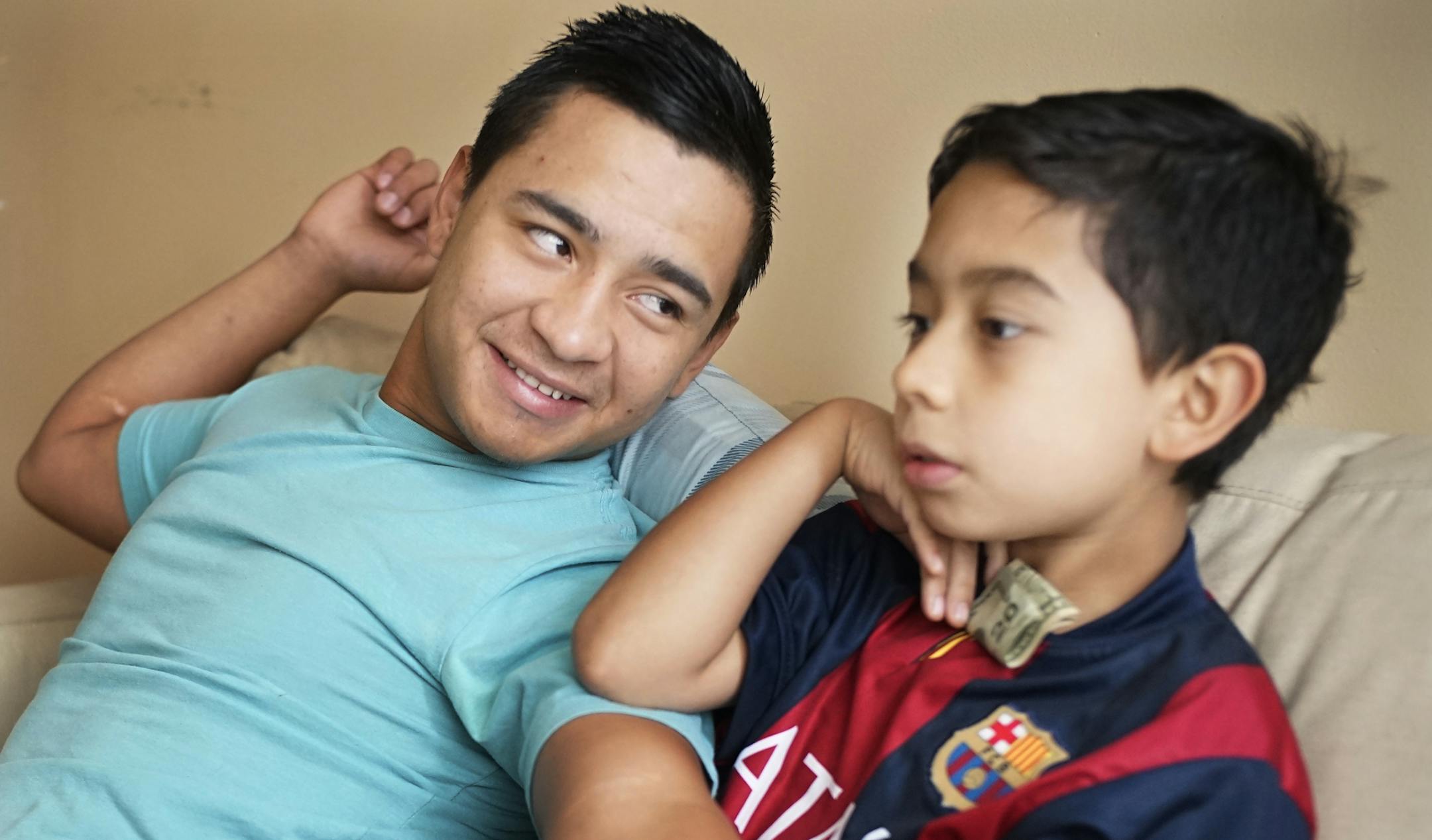 Elder Leiva, 17, gets support from his aunt Mary and his cousin Eulises, 9, with whom he shares a room.