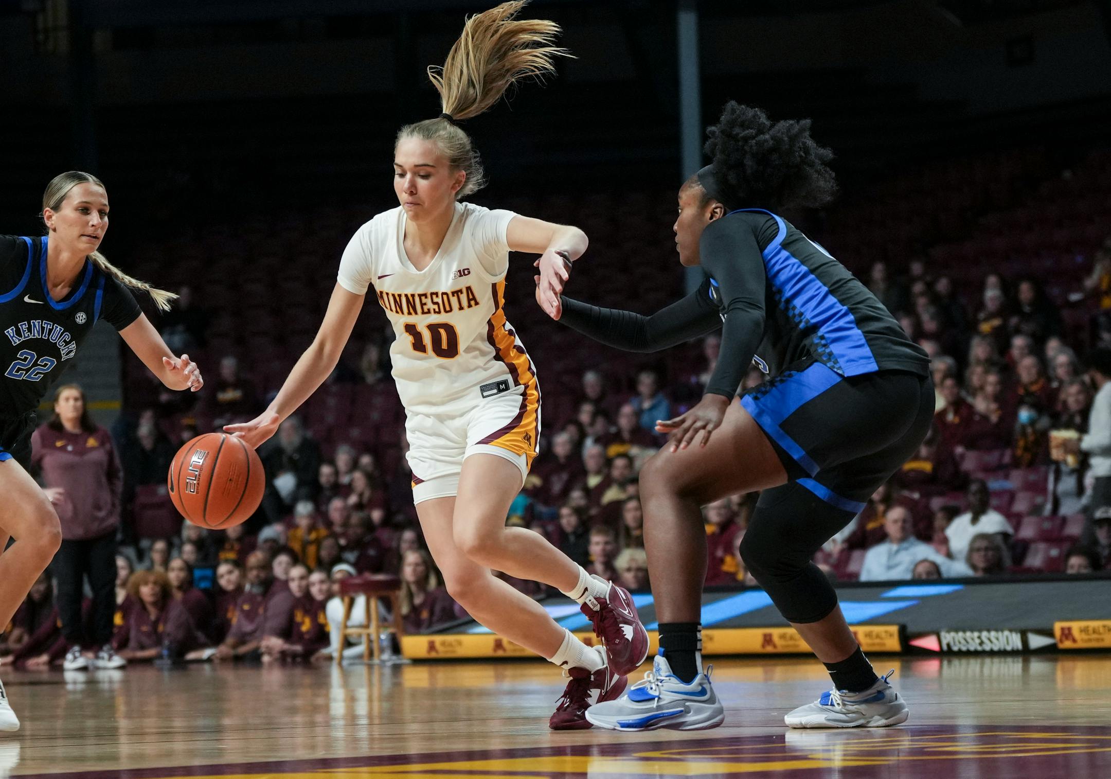 Minnesota Gophers guard Mara Braun (10) dribbles alongside Kentucky Wildcats forward Adebola Adeyeye (25) in the first half. The Gopher women's basketball hosted the Kentucky Wildcats on Wednesday, Dec. 7, 2022 at William's Arena in Minneapolis, Minn.