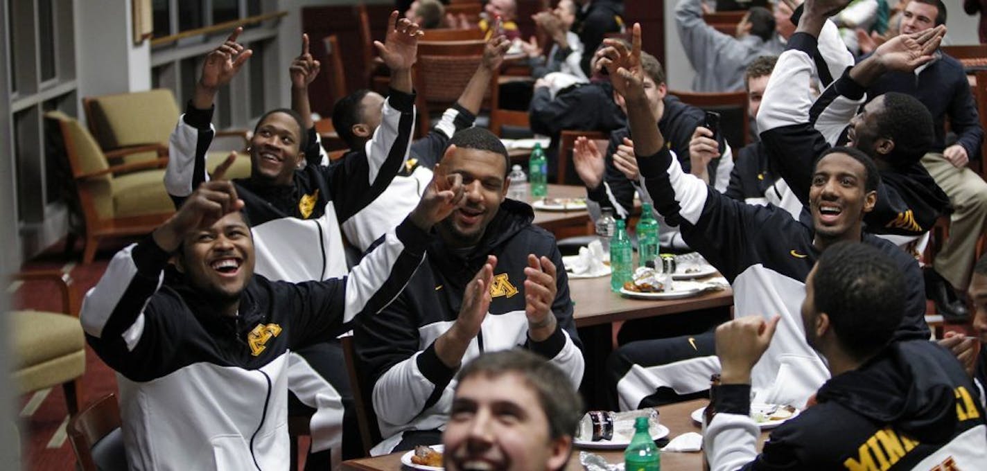 Gophers players react to the NCAA pairings announcement Sunday in the Pavilion Club room at the U of M. IDs... Front table is Maverick Ahanmisi; Maurice Walker; Austin Hollins (L to R). back table is Rodney Williams on left.; PHOTO CREDIT: Eric Miller - University of Minnesota