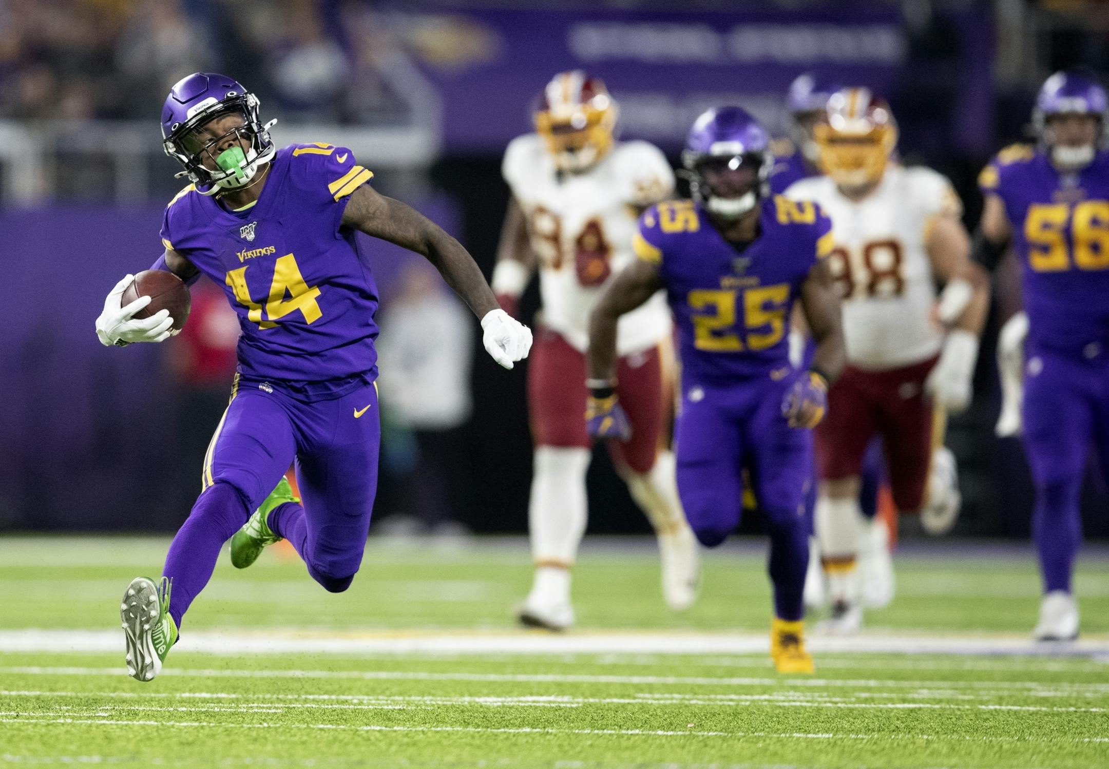 Stefon Diggs (14) ran away from Washington players on a long gain in the second quarter Thursday night. Diggs finished with 143 yards on seven catches.
