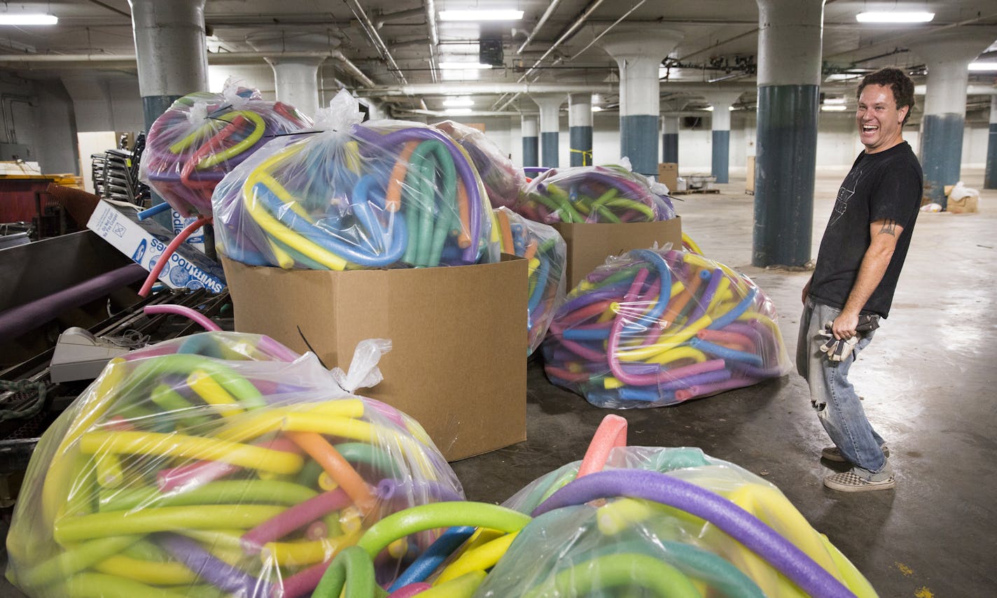 Chris Pennington, the creative director for Can Can Wonderland looks at a donation of 7,000 foam noodles that he received from Target.