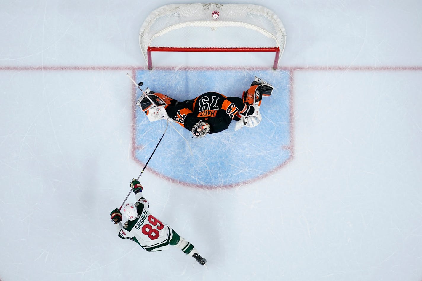 Philadelphia Flyers' Carter Hart (79) blocks a shot by Minnesota Wild's Frederick Gaudreau (89) during a shootout in an NHL hockey game, Thursday, March 23, 2023, in Philadelphia. (AP Photo/Matt Slocum)