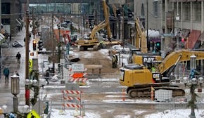 As seen from a skyway near Target, pedestrians make their way down Nicollet Mall, torn up for construction, Wednesday, Jan. 20, 2016.