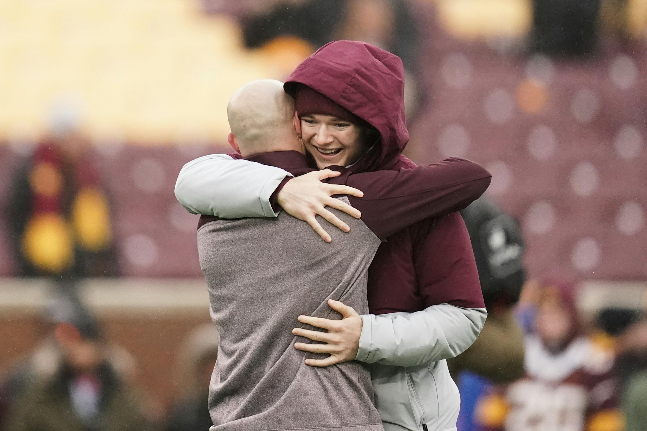 Gophers holder Casey O'Brien and Gophers football coach P.J. Fleck embraced before the Wisconsin game. O'Brien, who had undergone surgery only a few days earlier and went against his doctors' recommendation to be at the game, has beaten cancer four times.
