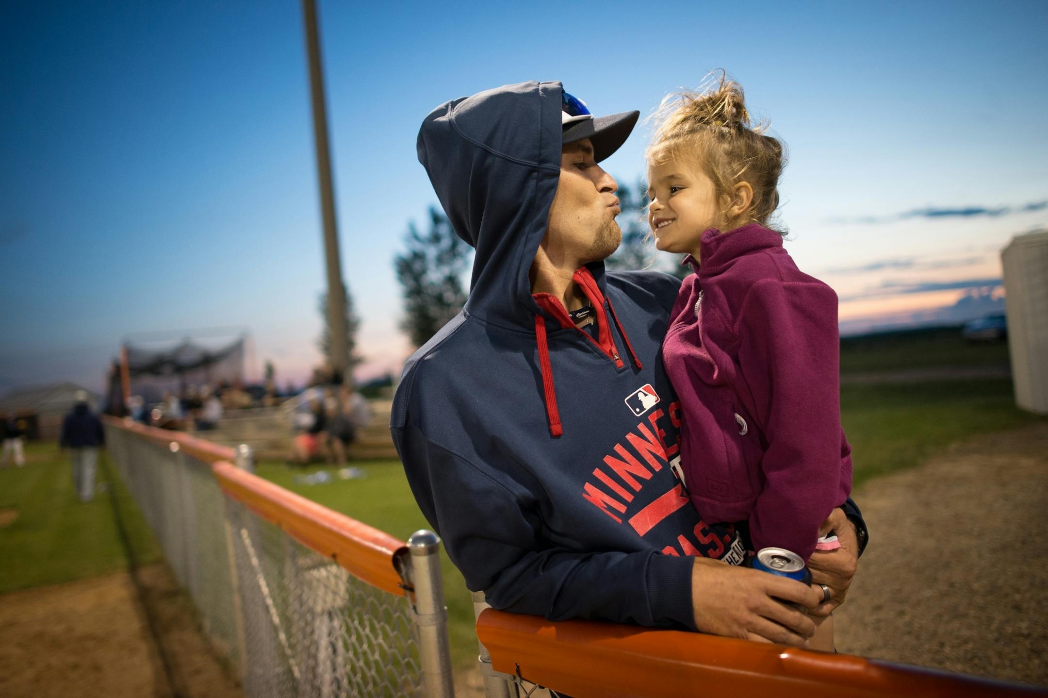 Richmond infielder Dylan Adams puckered up his lips before kissing his niece, Lydia Adams, 4, during the all-star game between the Stearns County League and the County Line League on Friday, June 30, 2017. Dylan's brother and Lydia's father also plays for Richmond.