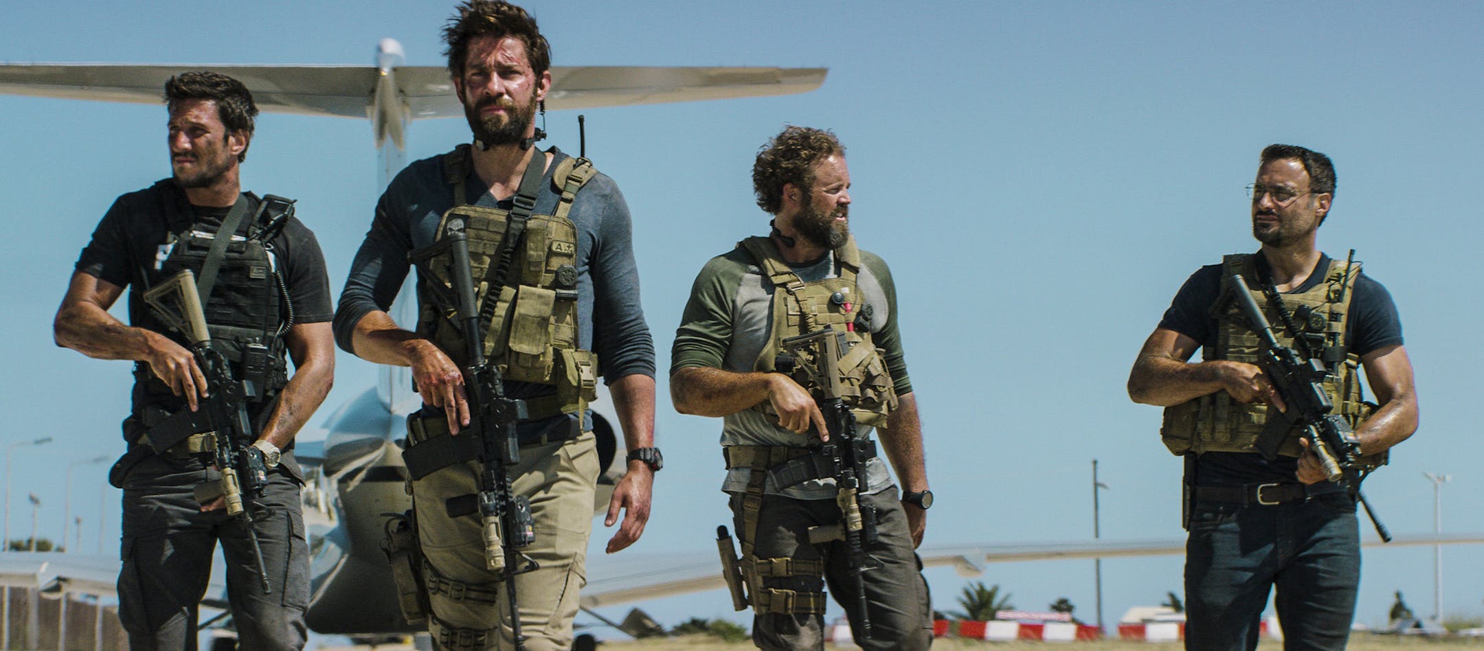 In this photo provided by Paramount Pictures shows Pablo Schreiber, from left, as Kris "Tanto" Paronto, John Krasinski as Jack Silva, David Denman as Dave "Boon" Benton and Dominic Fumusa as John "Tig" Tiegen, in the film, "13 Hours: The Secret Soldiers of Benghazi" from Paramount Pictures and 3 Arts Entertainment/Bay Films. The movie releases in U.S. theaters Jan. 15, 2016. (Christian Black/Paramount Pictures via AP) ORG XMIT: MIN2016011416095748