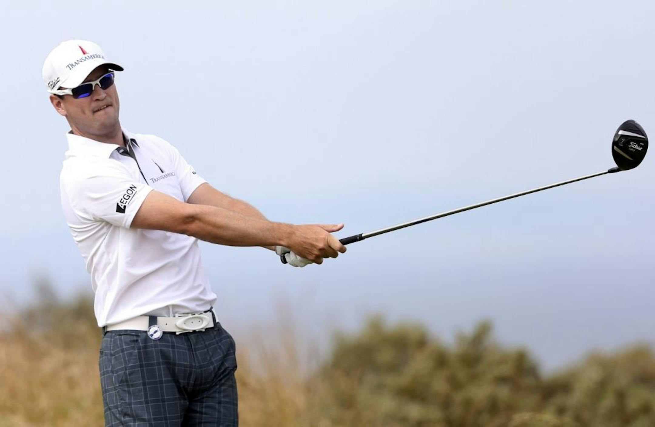 Zach Johnson of the United States plays a shot off the 6th tee during the first round of the British Open Golf Championship at Muirfield, Scotland, Thursday July 18, 2013.