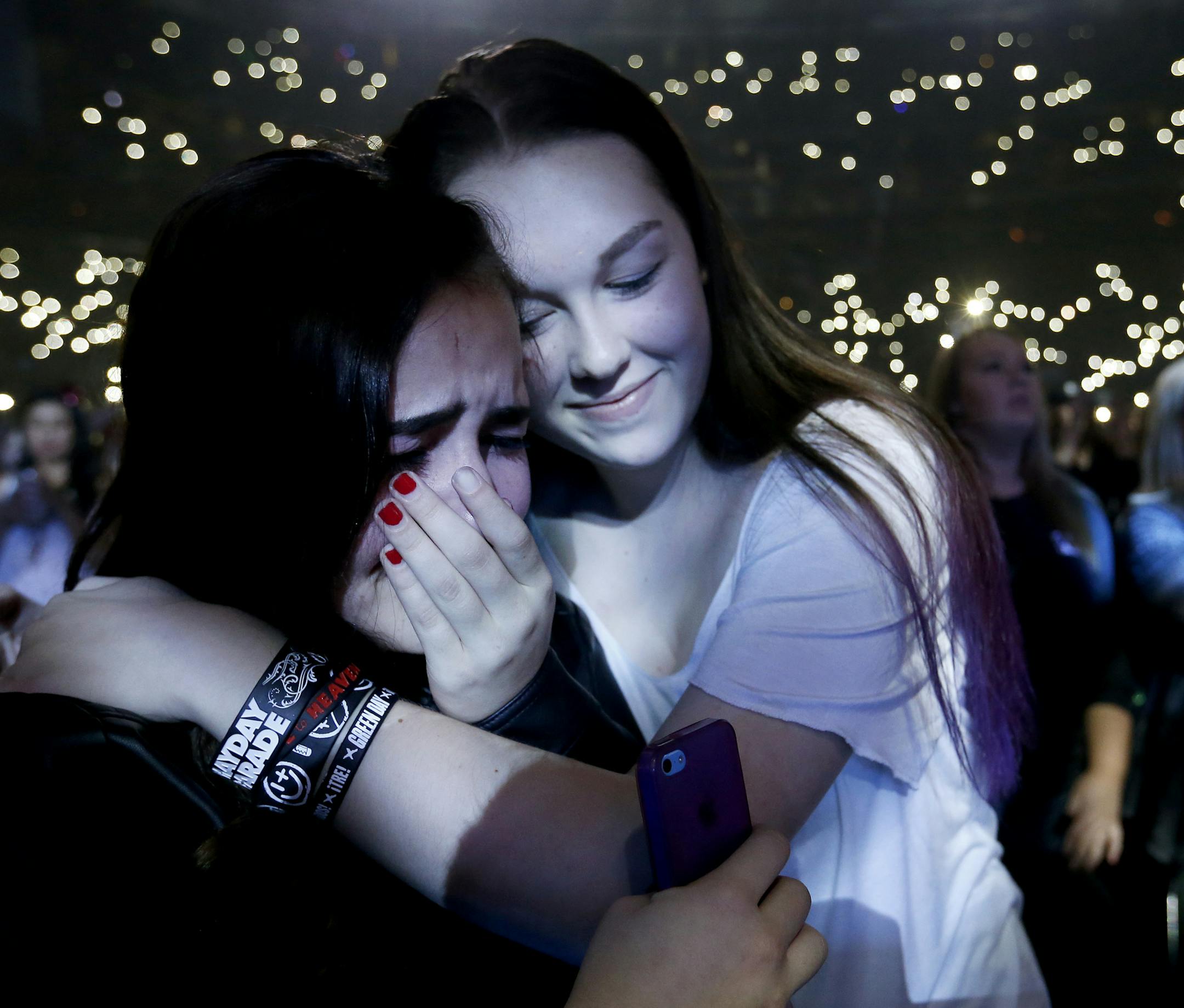 Chloe Bjork, 14, and Jami Morrow both of River Falls, WI embraced during a performance by Shawn Mendes at the KDWB Jingle Ball at the Xcel Energy Center in St. Paul on Monday night. ] CARLOS GONZALEZ ï cgonzalez@startribune.com - December 7, 2015, St. Paul, MN, Xcel Energy Center, 101.3 KDWB's annual Jingle Ball