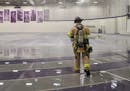 A firefighter walked through the flooded Anderson Athletic Center field house on Monday, Feb. 10. A softball hit and broke a sprinkler, causing the fl