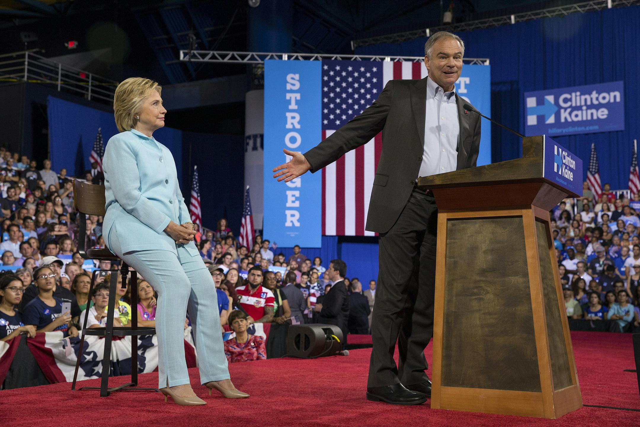 Hillary Clinton looks on as her running mate Sen. Tim Kaine of Virginia speaks during a rally at Florida International University in Miami, July 23, 2016. Clinton believes Kaine, a battleground state politician with working-class roots and fluency in Spanish, could boost her chances to defeat Donald Trump in November. (Ruth Fremson/The New York Times)