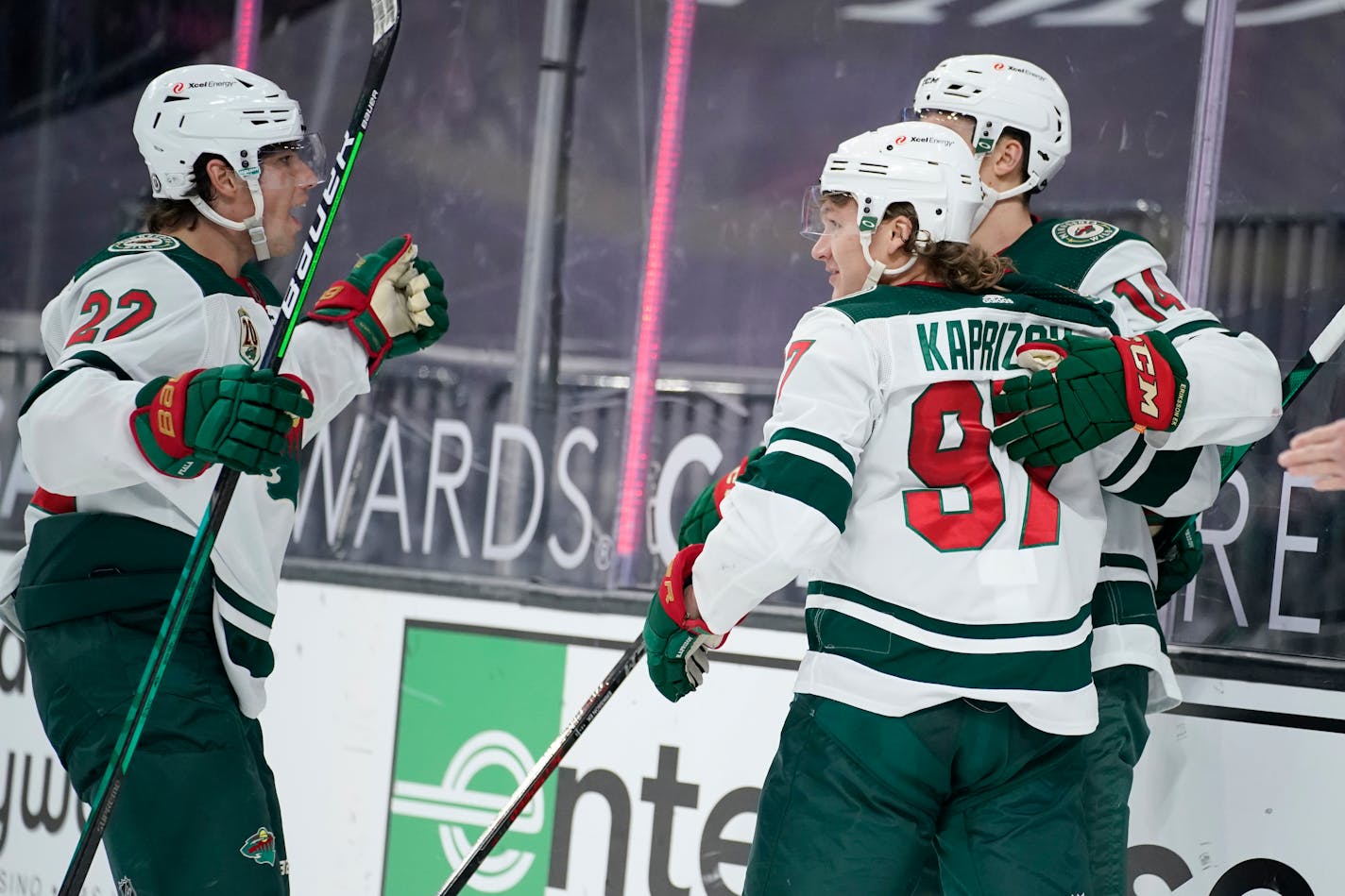 Minnesota Wild's Kevin Fiala (22) celebrates after Kirill Kaprizov (97) scored against the Vegas Golden Knights during the third period of an NHL hockey game Saturday, April 3, 2021, in Las Vegas. (AP Photo/John Locher)