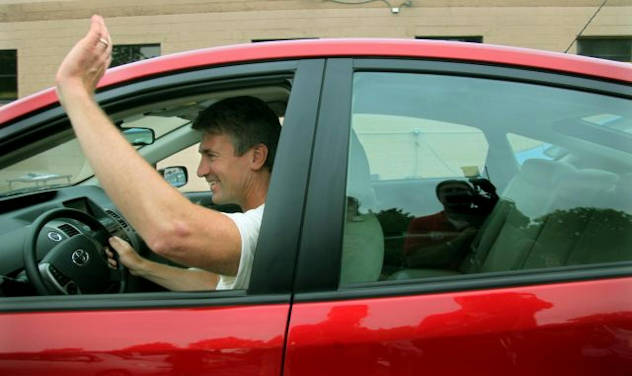 Mayor R. T. Rybak waved Tuesday as he started off on a test drive of his official car, a Toyota Prius gas/electric hybrid that has been converted by a south Minneapolis company so its more-powerful battery can be charged by plugging it in at home.