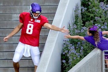 Vikings quarterback Kirk Cousins greeted a fan before a training camp practice last season. 