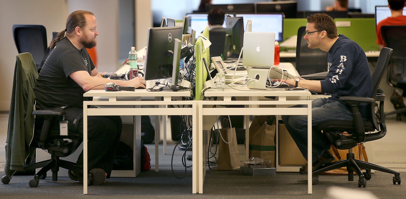 Nate Anderson, left, and Rich Howard worked at their desks at SPS Commerce, Tuesday, May 19, 2015 in downtown Minneapolis, MN. ] (ELIZABETH FLORES/STAR TRIBUNE) ELIZABETH FLORES &#x2022; eflores@startribune.com