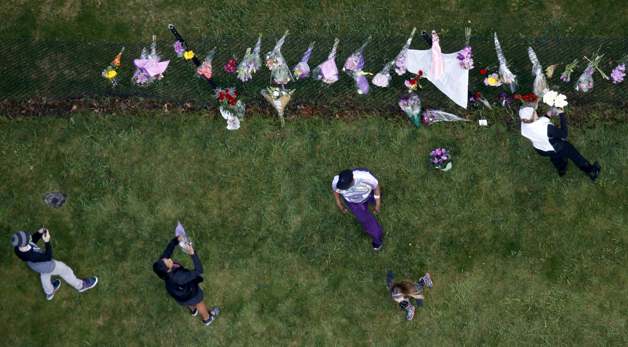 Fans placed flowers and took pictures at a makeshift memorial at Paisley Park Studios in Chanhassen, MN. Musician Prince was found dead at the site on Thursday morning.