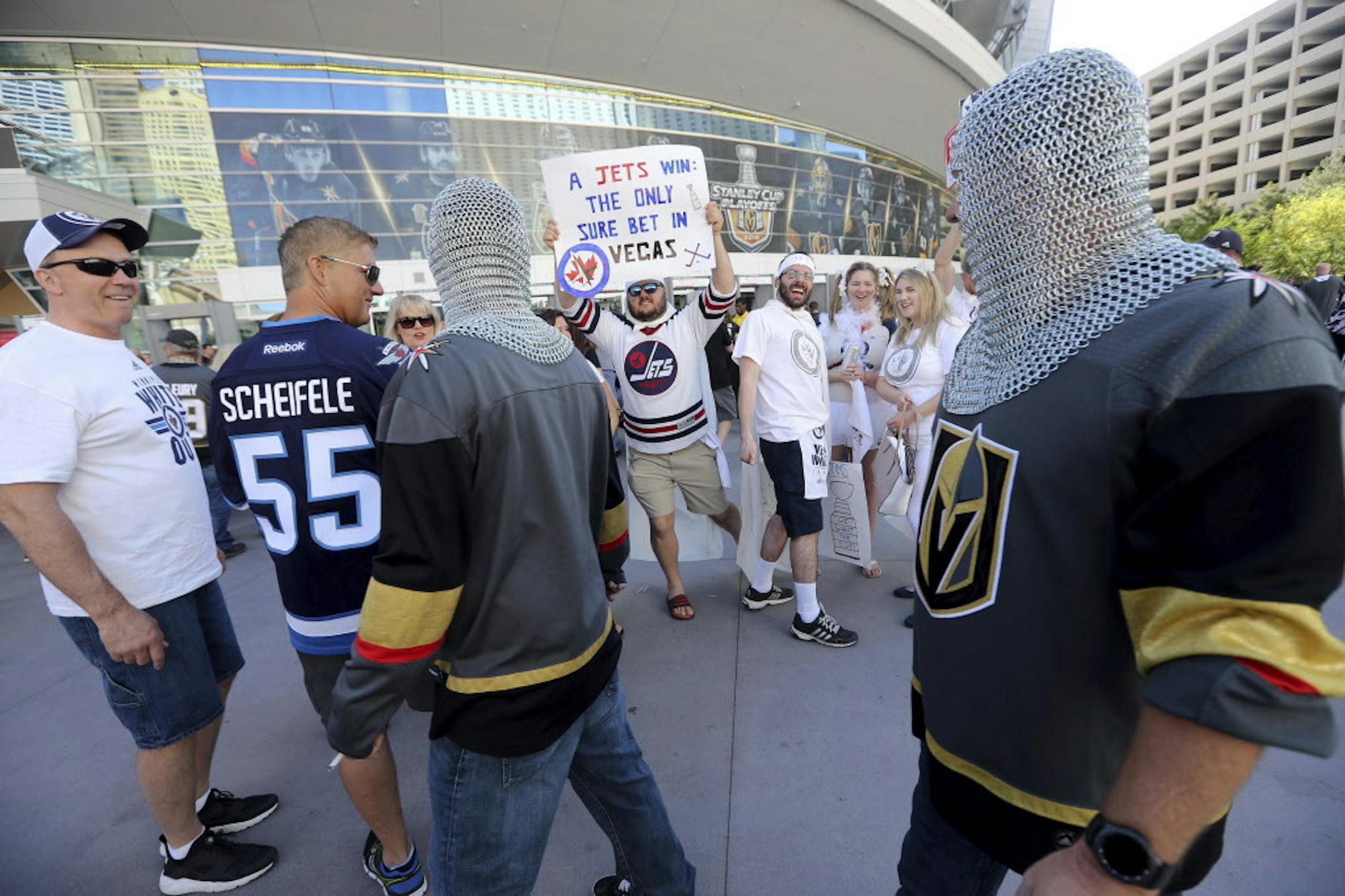 Fans of the Winnipeg Jets and of the Vegas Golden Knights walk pass each other outside the arena before Game 3 of the NHL hockey playoffs Western Conference finals, in Las Vegas on Wednesday, May 16, 2018. (Trevor Hagan/The Canadian Press via AP)