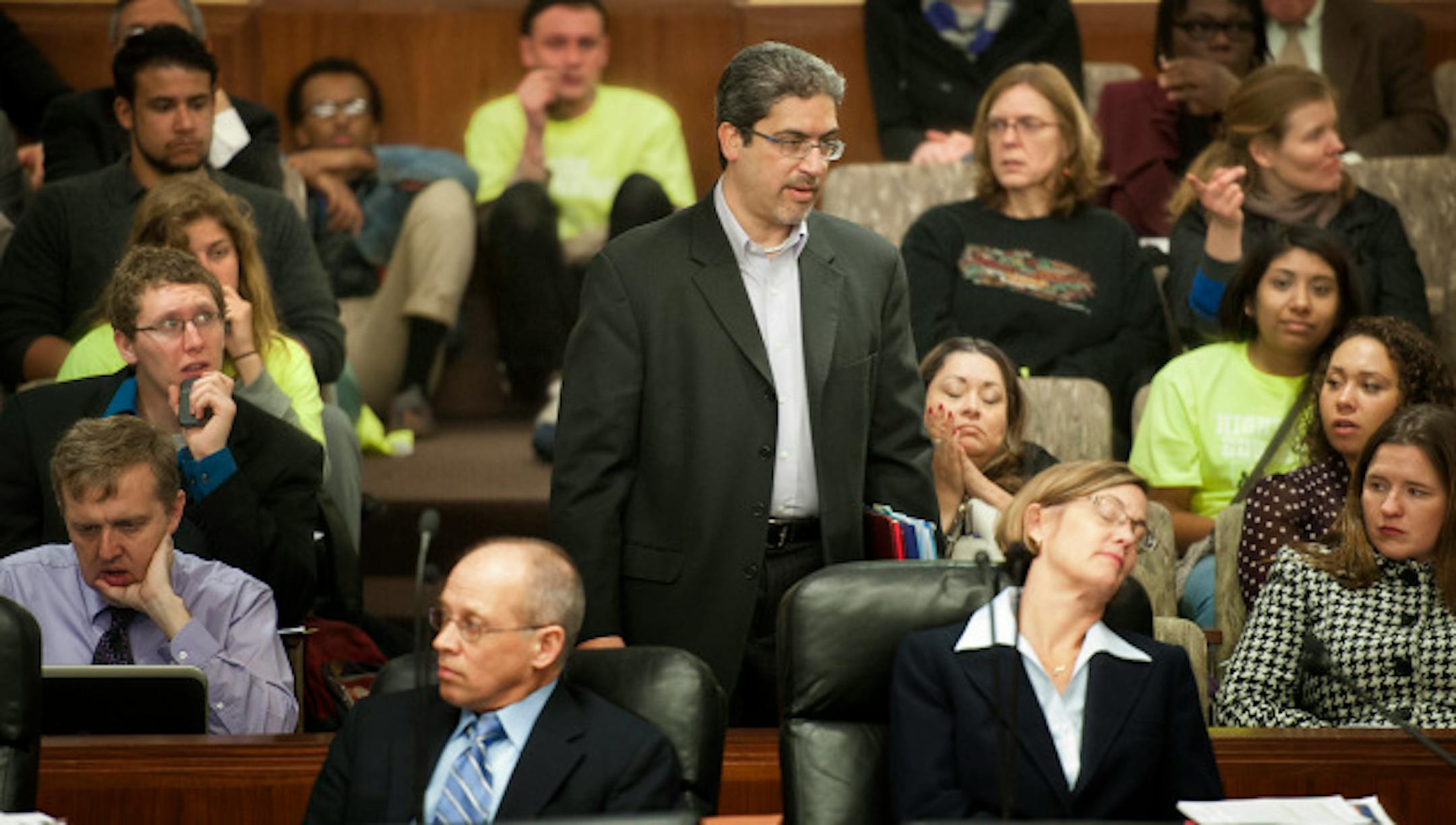 Rep. Carlos Mariani (D-St. Paul) walked through the crowd of the higher education finance and policy committee while legislators heard testimony on a separate issue before hearing his bill which would allow undocumented students to pay instate tuition to Minnesota colleges and universities.  - (D-St. Paul) Wednesday, April 4, 2013  ]   GLEN STUBBE * gstubbe@startribune.com