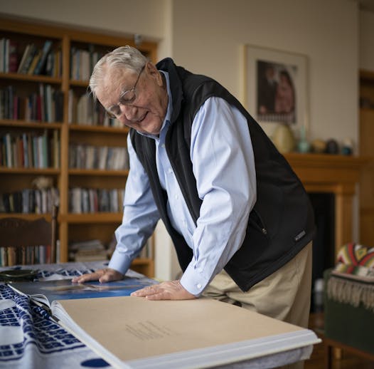 In his Mill District condo, former Vice President Walter Monday paged through a massive photography book by Craig Blacklock on the St. Croix and Namekagon rivers, for which he wrote an essay.