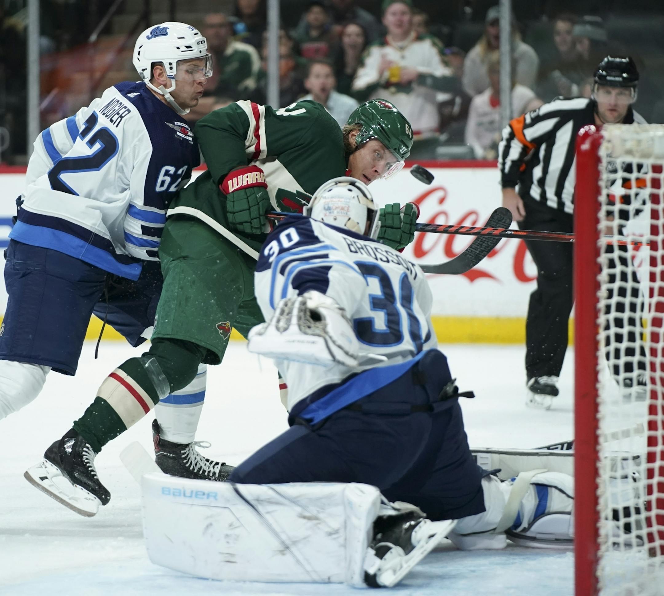 Minnesota Wild right wing Mikael Granlund (64) shot the puck at Winnipeg goaltender Laurent Brossoit in the firsts periiod. The puck was tipped in by teammate Eric Staal for the the first goal of the game.