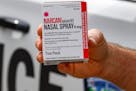 FILE - In this Thursday, Sept. 12, 2019 file photo, a police officer holds a box of Narcan, a drug used to treat opioid overdoses, that the department