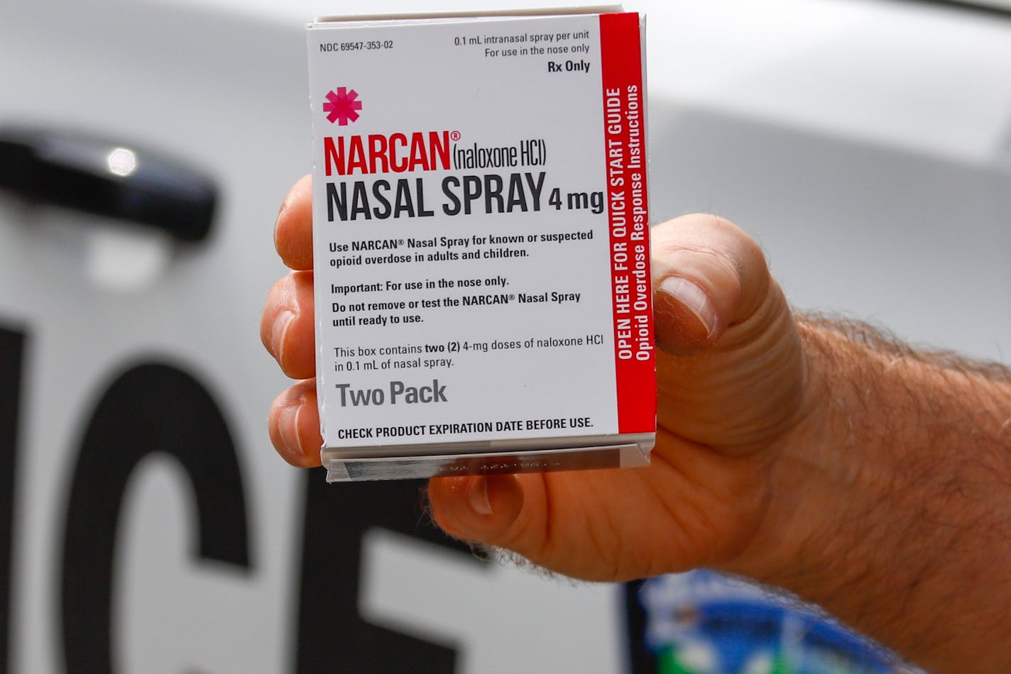 FILE - In this Thursday, Sept. 12, 2019 file photo, a police officer holds a box of Narcan, a drug used to treat opioid overdoses, that the department officers carry in their patrol vehicles in Jackson Township, Butler County, Pa. More companies could begin making the easy-to-use version of the medication under a deal announced Thursday, Jan. 2, 2020 by New York's attorney general. (AP Photo/Keith Srakocic)