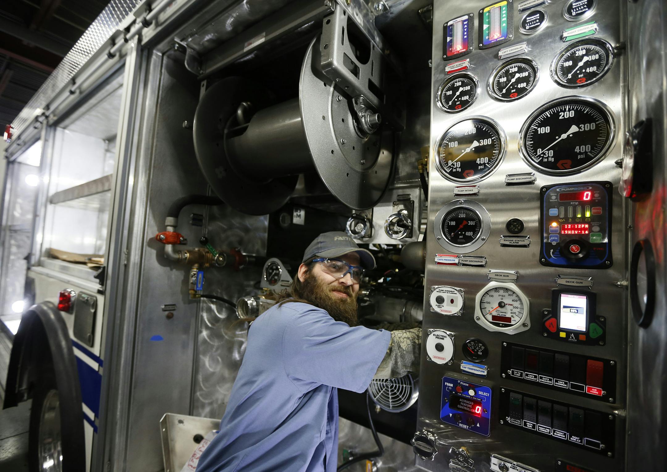 Andy Isaman an employee at Rosenbauer installed wiring for the pumps on a new fire truck Wednesday November 19, 2014 in Wyoming, Minnesota.] Rosenbauer in Wyoming, MN manufactures fire trucks that are used around the globe. Jerry Holt Jerry.holt@startribune.com