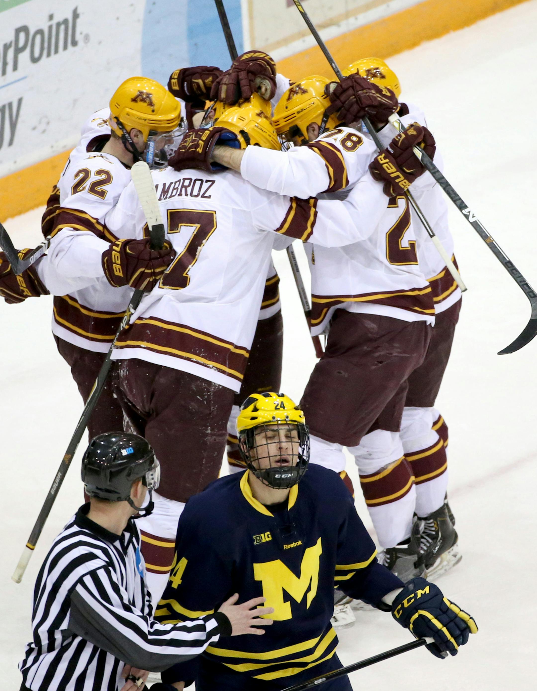 To the dismay of Michigan's Kevin Lohan (24) University of Minnesota players celebrate Seth Ambroz's goal during the first period Friday, Feb. 13, 2015.](DAVID JOLES/STARTRIBUNE)djoles@startribune.com The University of Minnesota men's hockey versus the University of Michigan Friday, Feb. 13, 2015.