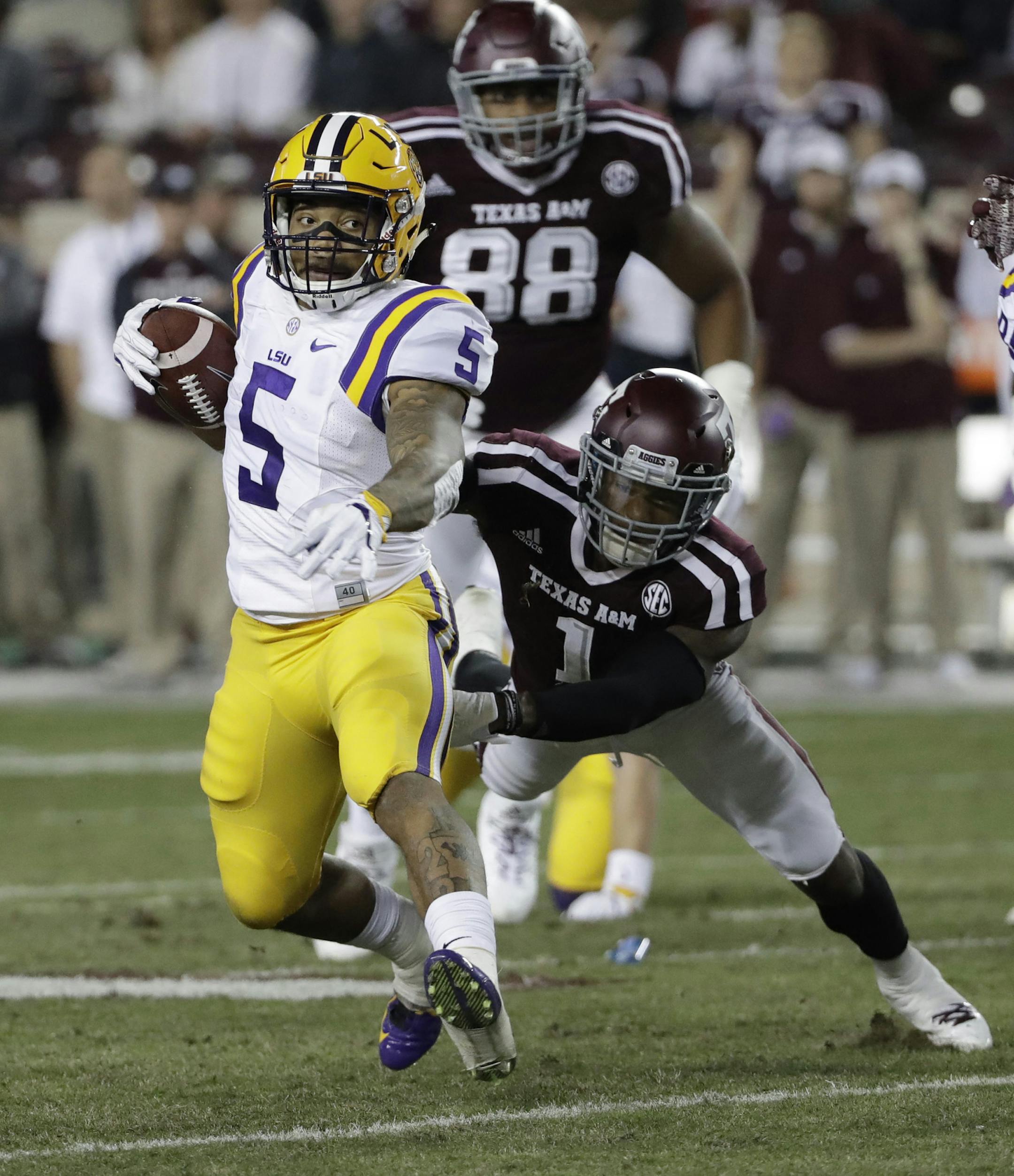 LSU running back Derrius Guice (5) breaks away from Texas A&M defensive back Nick Harvey (1) as he runs for a touchdown during the first quarter of an NCAA college football game Thursday, Nov. 24, 2016, in College Station, Texas. (AP Photo/David J. Phillip) ORG XMIT: MIN2017082520291597