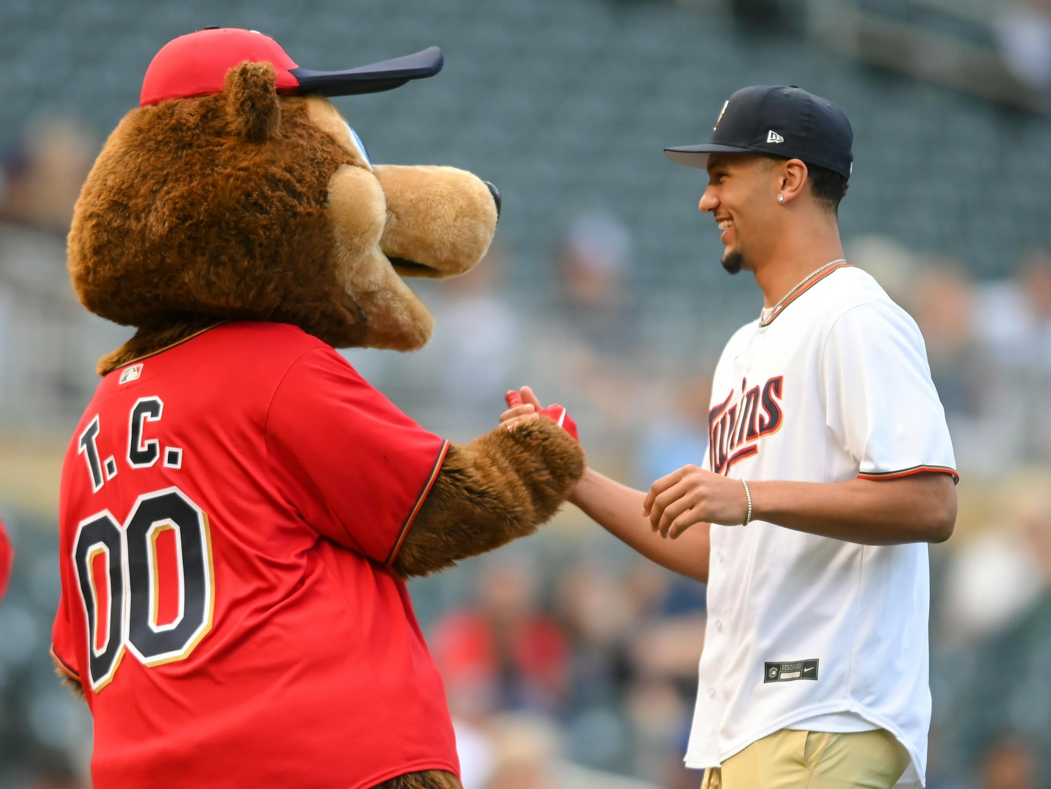 Gonzaga star basketball player and former Minnehaha Academy star Jalen Suggs high fived T.C. Bear after he threw the ceremonial first pitch Thursday night.