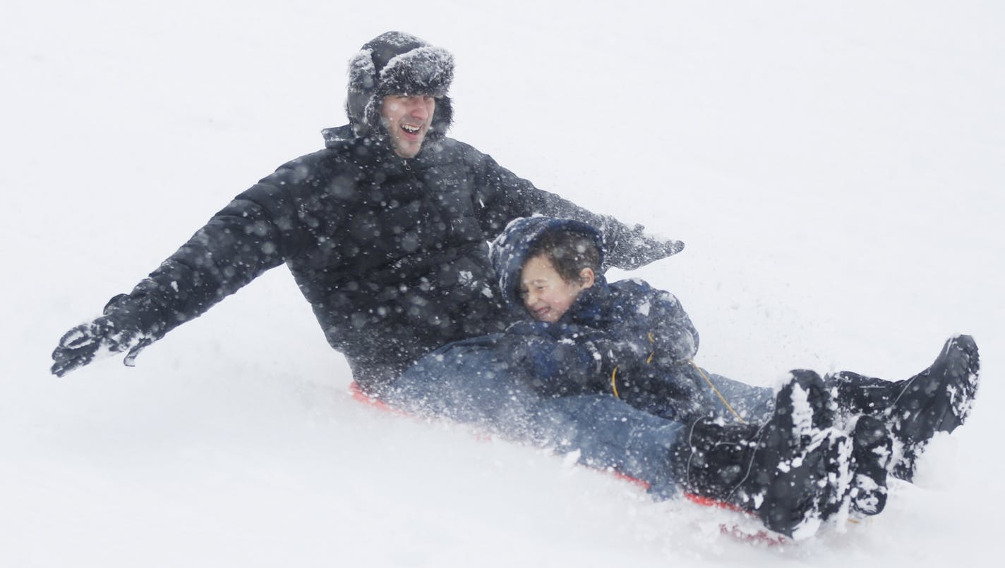 On a hill at Lyndale Farmstead in Minneapolis, Julian Fischer and his son, Zavoli, 5, took advantage of the Sunday's snow.