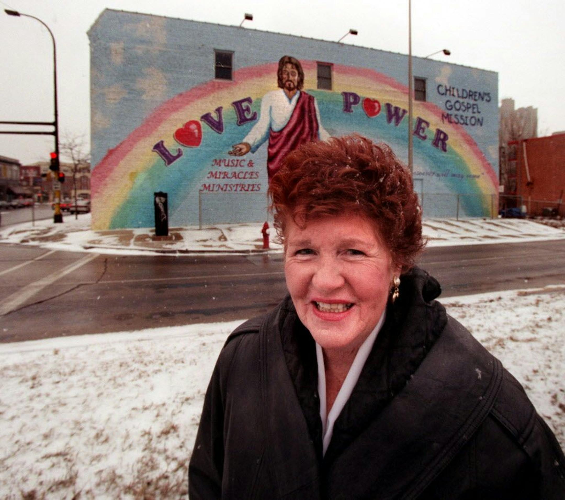 Outside the church, the west wall of which we see behind Pastor Ann Sandell.