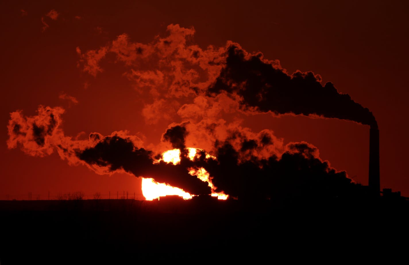 In this March 8, 2014 file photo steam from the Jeffrey Energy Center coal-fired power plant is silhouetted against the setting sun near St. Marys, Kan. As President Barack Obama prepares to announce tougher new air quality standards affecting coal-fired power plants, lawmakers in about a half-dozen state already have acted pre-emptively. Not to toughen their own standards, but to make it tougher to enforce the new federal ones. (AP Photo/Charlie Riedel, File)