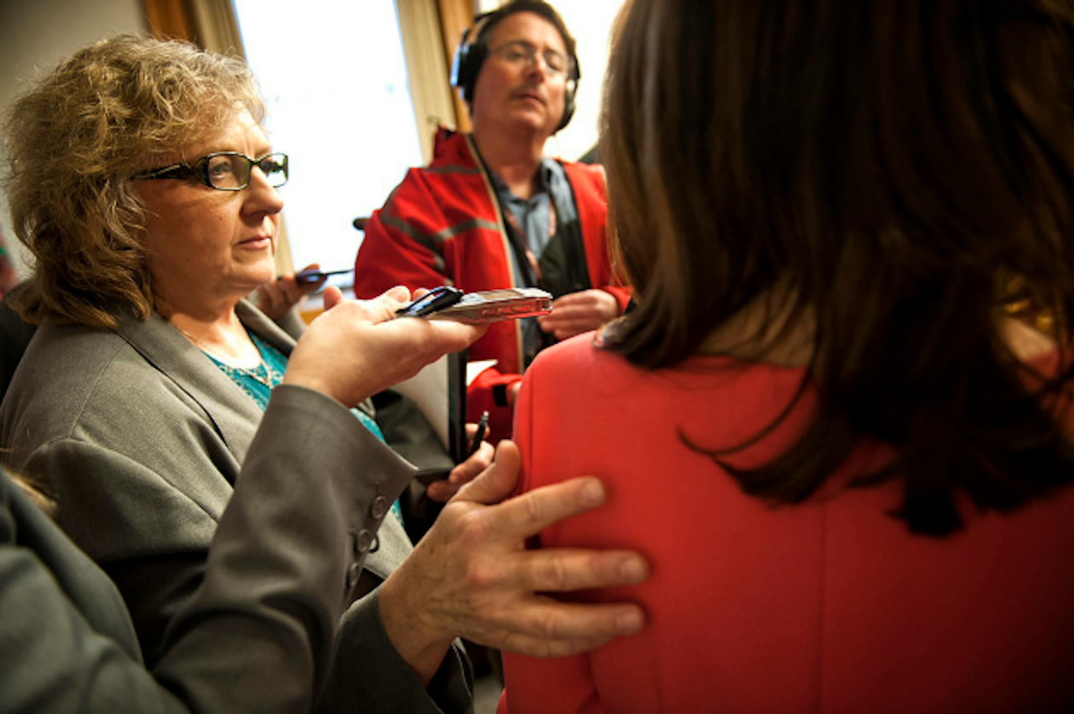 Aide Deb Steiskal blocked Star Tribune reporter Rachel Stassen-Berger, left.   Congresswoman Michele Bachmann and State Senator Sean Nienow (R-Cambridge) held a joint news conference to discuss problems with Medicaid reimbursement rates paid to doctors in Minnesota.  Both are introducing legislation increasing accountability and transparency.  When the questioning turned to Rep. Bachmann's ethics problems from her 2012 presidential campaign, aides closed in blocking reporters and photographers and ushered her out of the room.    Tuesday, April 9, 2013  ]   GLEN STUBBE * gstubbe@startribune.com