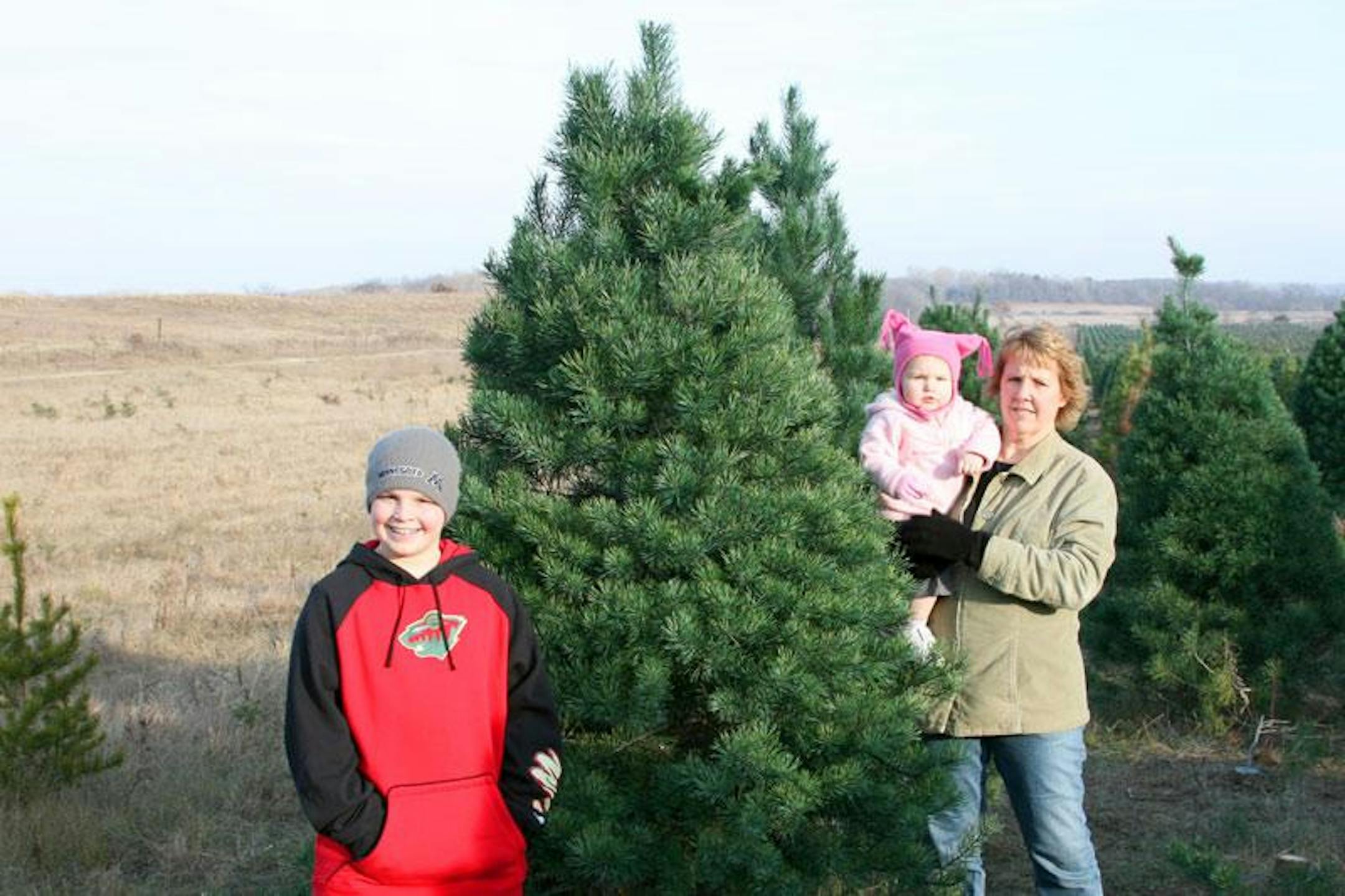 My family poses for a quick snapshot by the tree we cut for holiday decorating.
