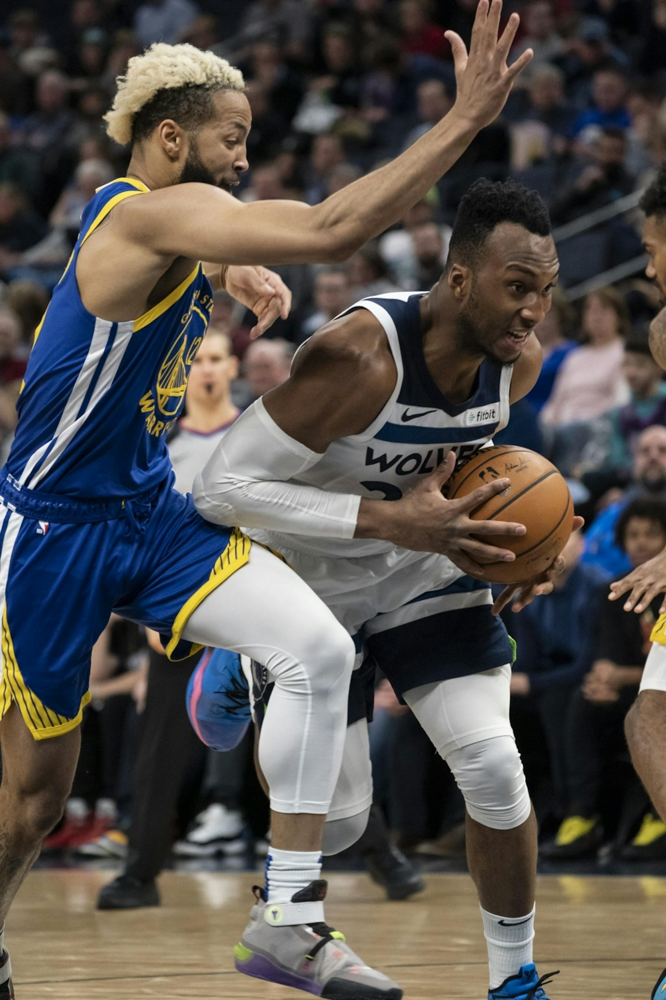 Minnesota Timberwolves guard Josh Okogie (20) pushed down court past Golden State Warriors guard Ky Bowman (12) in the second half.