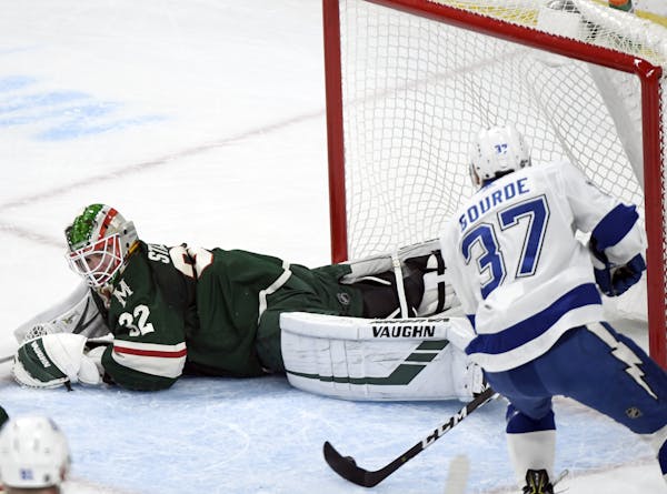Tampa Bay Lightning's Yanni Gourde (37) scores a goal against Minnesota Wild goaltender Alex Stalock (32) in the first period of an NHL hockey game Sa