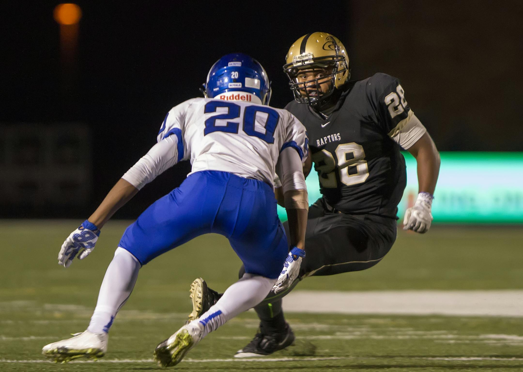 Eastridge RB 28 Dominik London cuts up the field while Woodbury WR 20 Jake West prepares for the tackle as the Eastridge Raptors hosted the Woodbury Royals at the Raptor's Nest at East Ridge High School on October 9, 2015. [Special to Star Tribune Matt Blewett ï matt@mattebphoto.com 959967 20041434A SLUG: PREP101015.east]