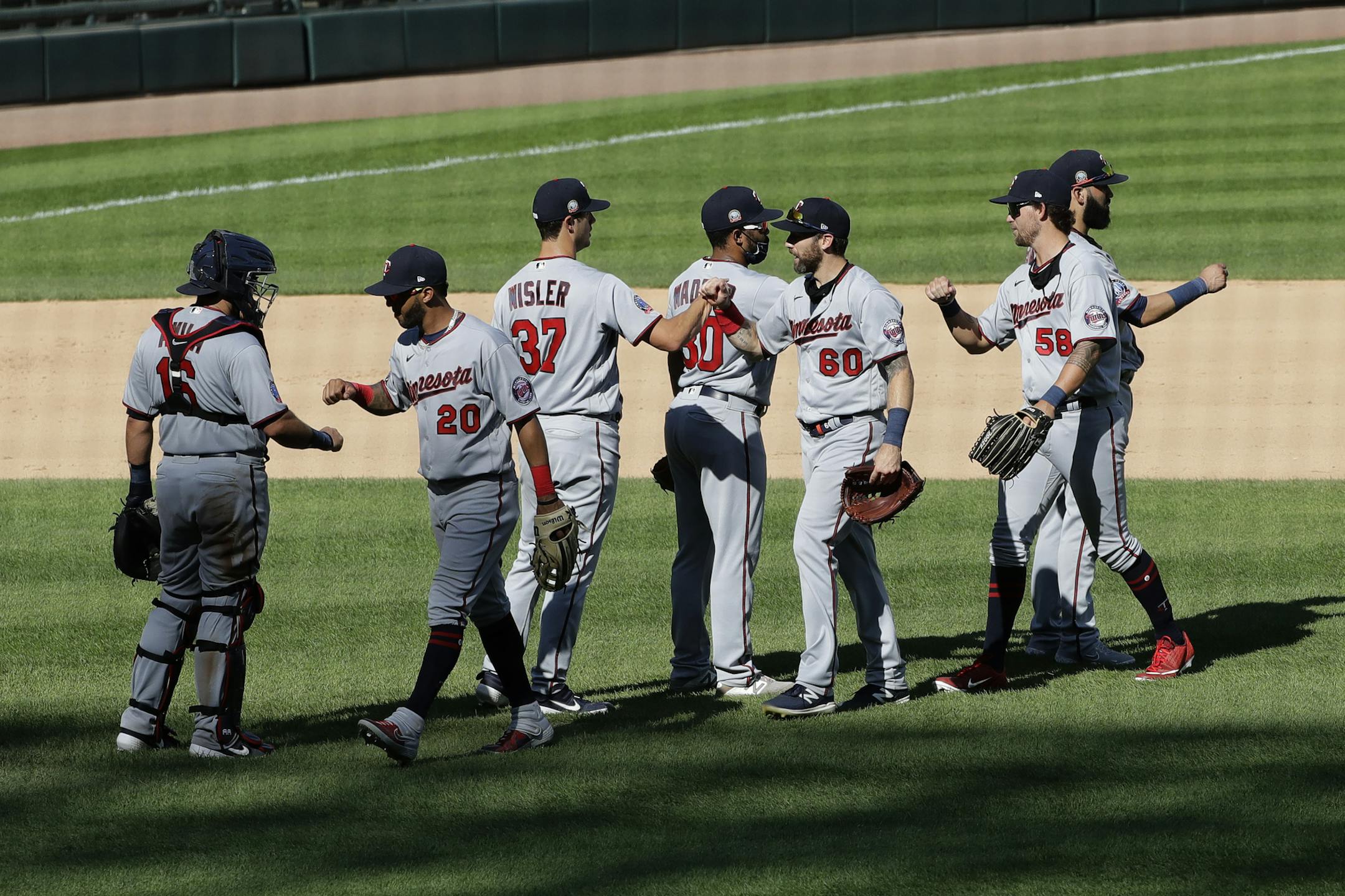 Minnesota Twins players celebrate after they defeated the Chicago White Sox in a baseball game in Chicago, Sunday, July 26, 2020. (AP Photo/Nam Y. Huh)