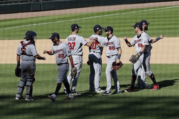 Minnesota Twins players celebrate after they defeated the Chicago White Sox in a baseball game in Chicago, Sunday, July 26, 2020. (AP Photo/Nam Y. Huh