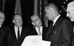 ** HOLD FOR RELEASE UNTIL 12:01 AM EST TUESDAY NOV. 30, 2010 ** FILE - In this Aug. 6, 1965, file photo U.S. President Lyndon B. Johnson holds the sig