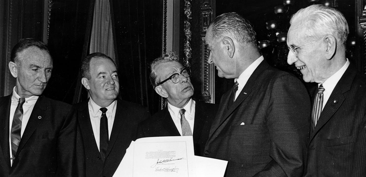 ** HOLD FOR RELEASE UNTIL 12:01 AM EST TUESDAY NOV. 30, 2010 ** FILE - In this Aug. 6, 1965, file photo U.S. President Lyndon B. Johnson holds the signed Voting Rights Act as he chats with Sen. Everett Dirksen, R-Ill., center, in the President's Room in Washington. Meetings between presidents and congressional leaders of both parties used to be hum drum, says Calvin Mackenzie, a presidential historian at Colby College. "Lyndon Johnson would sit down with Everett Dirksen at the end of the day. Th