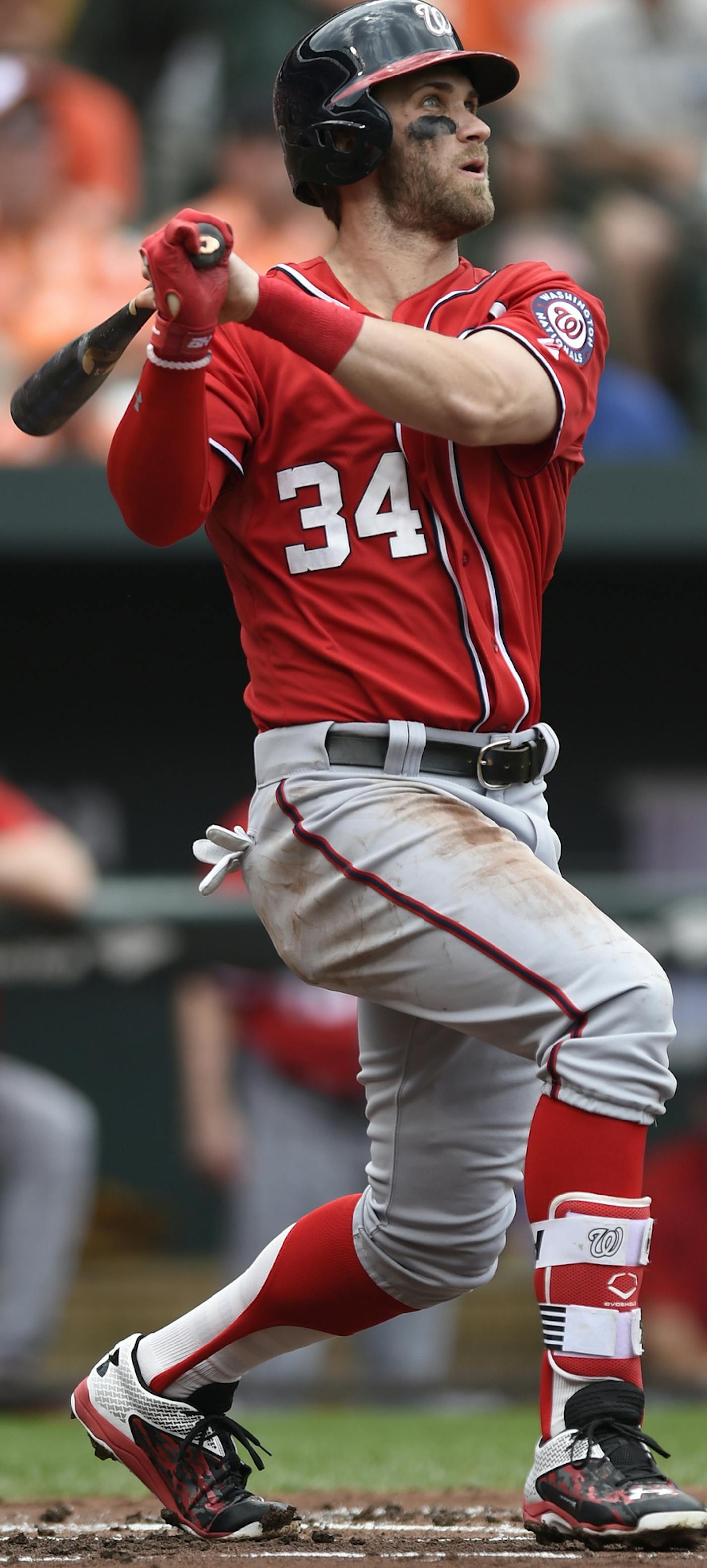 Washington Nationals' Bryce Harper follows through on a double against the Baltimore Orioles in the first inning of a baseball game Sunday, July 12, 2015, in Baltimore. (AP Photo/Gail Burton) ORG XMIT: MDGB102