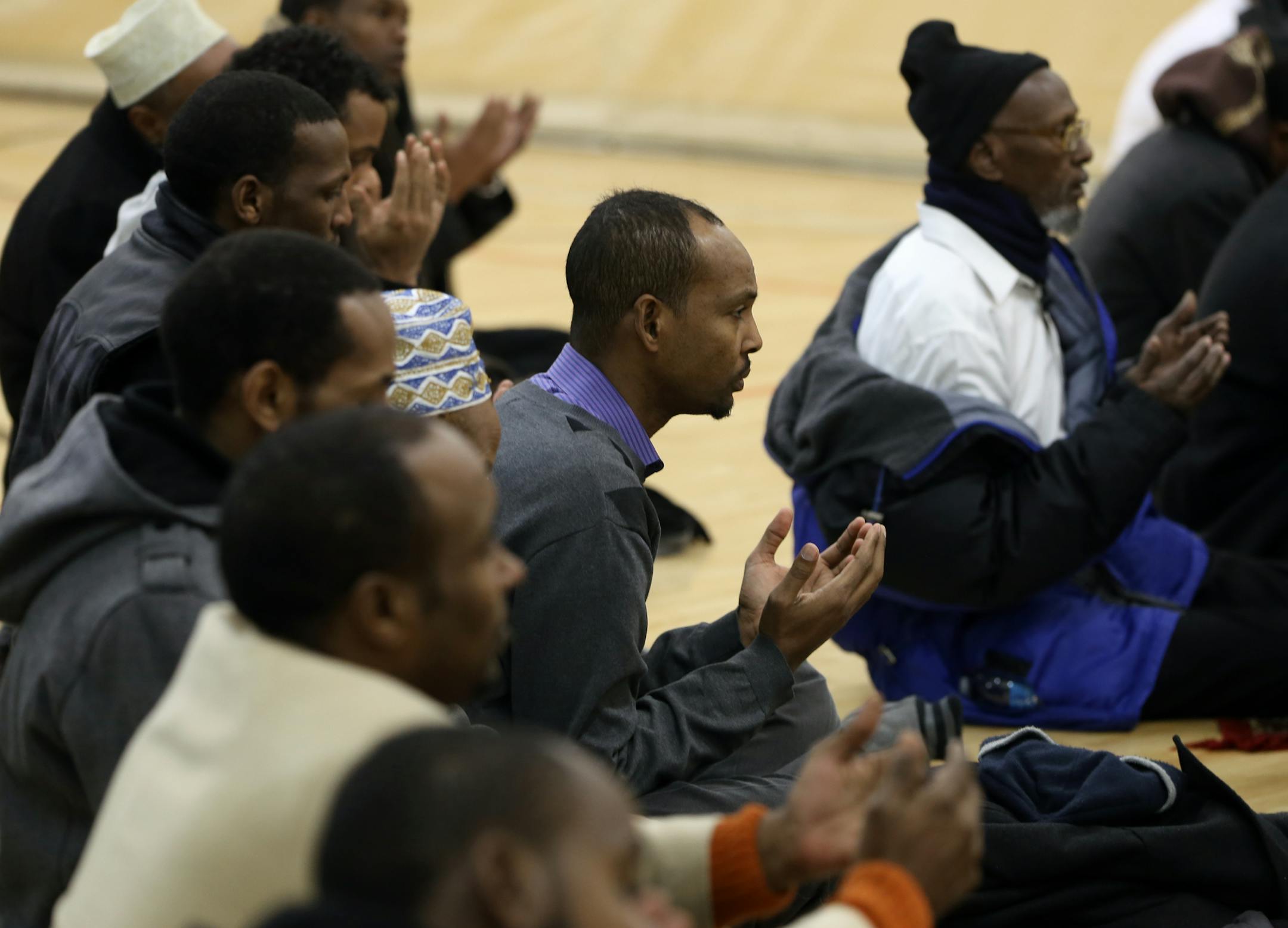 Members of the Cedar Riverside Islamic and Somali community attended Friday prayers at the Brian Coyle Center, because the mosque was damaged in the new years day fire on Cedar Ave. The fire displaced the Masjid Dar Al-Hijrah mosque and the Islamic Civic Society of America from their building that wraps around the destroyed grocery-apartment building.] Bruce Bisping/Star Tribune bbisping@startribune.com