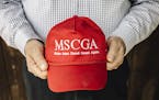 John Palmer holds a hat modeled after President Donald Trump's signature merchandise in St. Cloud, Minn., on May 16, 2019. As more Somali refugees arr