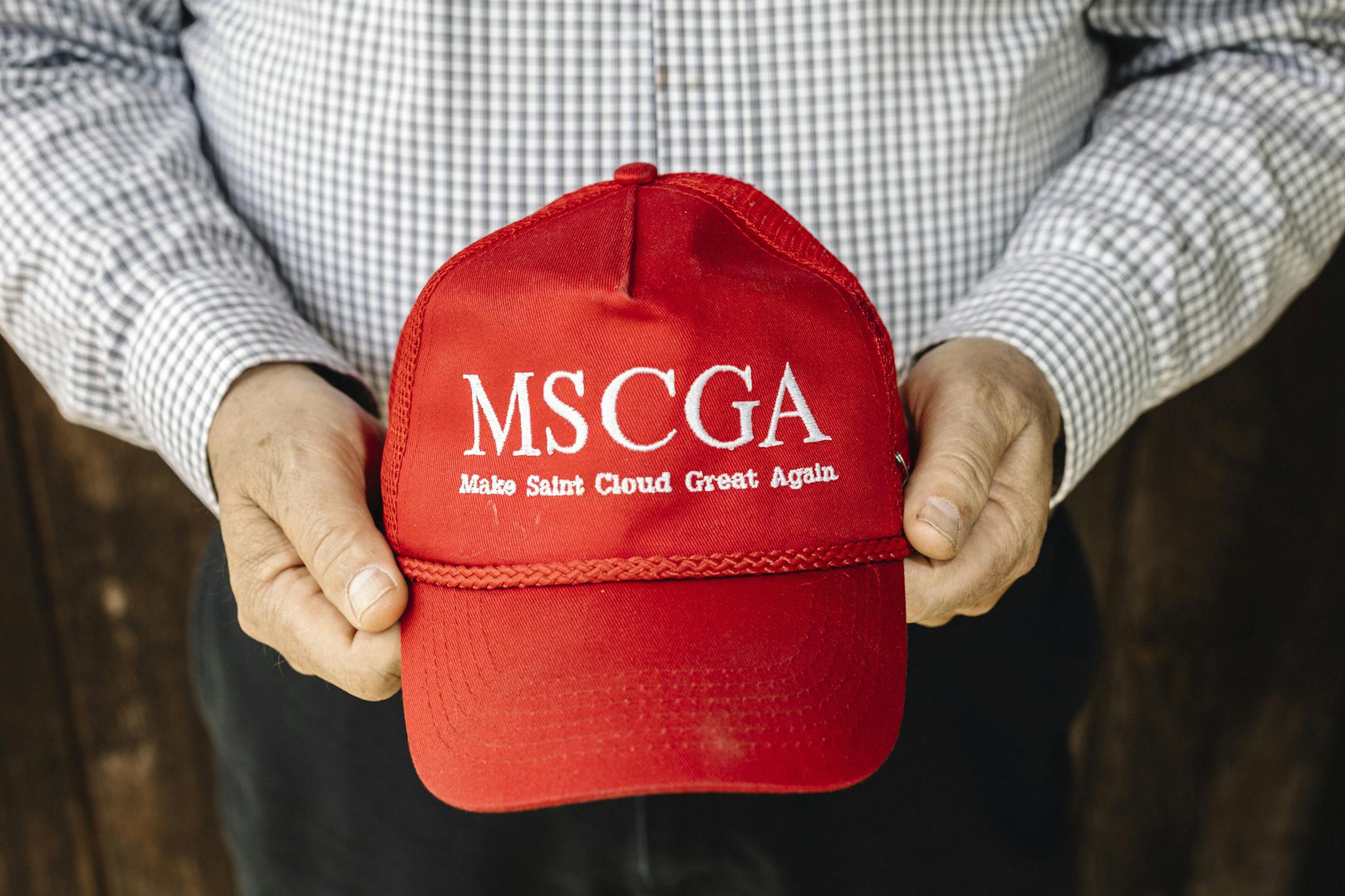 John Palmer holds a hat modeled after President Donald Trump's signature merchandise in St. Cloud, Minn., on May 16, 2019. As more Somali refugees arrive in St. Cloud, white anti-immigration activists have pressed an increasingly explicit anti-Muslim agenda. (William Widmer/The New York Times)